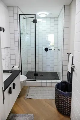 a bathroom with a shower with a toilet and a sink at BGS Luxury -Two-bed -Nine Palms in Cape Town