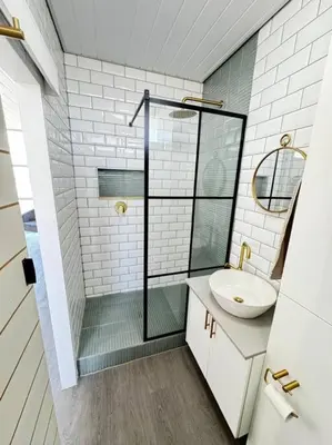 a bathroom with a sink and a glass shower at Soete Rus Strand in Cape Town