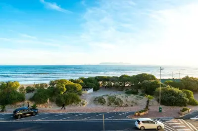 a view of the ocean with cars parked in a parking lot at Soete Rus Strand in Cape Town