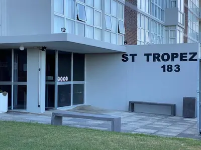 a building with a sign that reads strosis at Soete Rus Strand in Cape Town