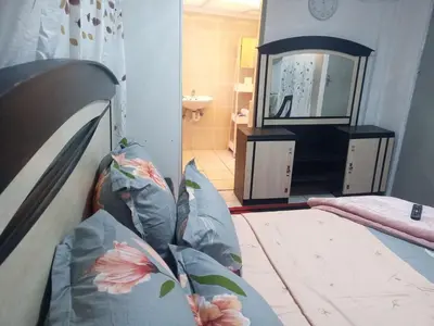 a bedroom with a bed and a mirror in a room at One Bedroom Apartment in Cape Town