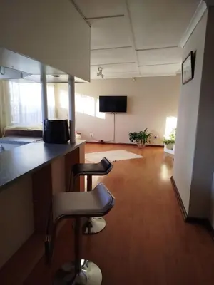 an empty room with two stools in an office at Mountain View Apartment in Cape Town