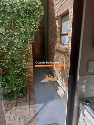 an outside entrance to a brick building with a window at Voëlklip garden flat in Hermanus