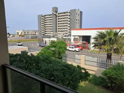 a view of a city with a car on a street at 8 Marina Sands beach apartment in Cape Town
