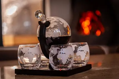 a tea kettle and three glasses on a table at The Glass Castle Retreat in Sir Lowry Pass