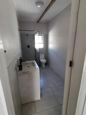 a bathroom with a toilet and a sink at Shekinah at Sea in Kleinmond