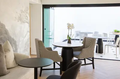 a dining room with tables and chairs and a table at Coco Queen in Paarl