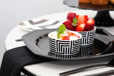 a plate with two bowls of strawberries on a table at Coco Queen in Paarl