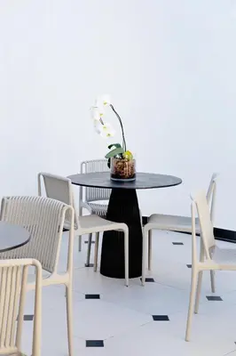 a table with chairs and a table with a plant on it at Coco Queen in Paarl