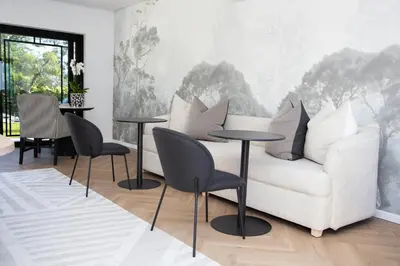 a living room with a white couch and tables at Coco Queen in Paarl