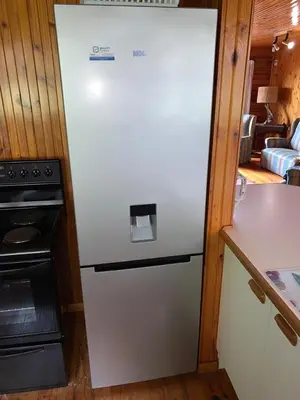 a white refrigerator in a kitchen with a stove at Bay View Cabin in Gordonʼs Bay