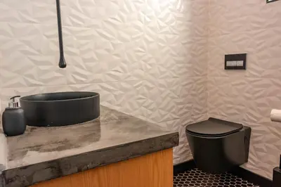 a bathroom with a sink and a toilet on a counter at The Glass Castle in Sir Lowry Pass