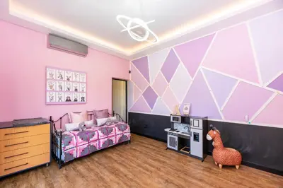 a bedroom with a bed and a room with purple walls at The Glass Castle in Sir Lowry Pass
