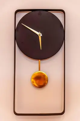 a clock with a pendulum and a spoon at Golden Sunset Room in Sir Lowry Pass