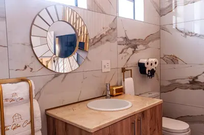 a bathroom with a sink and a mirror at Serenity Vista Retreat in Cape Town