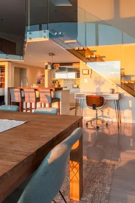 a dining room and kitchen with a table and chairs at Penthouse with a view to die for! in Cape Town