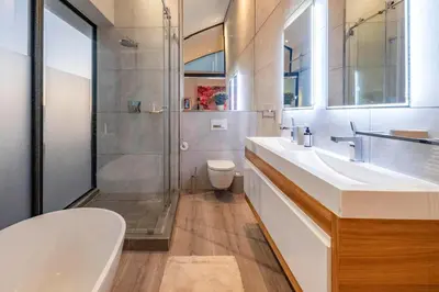 a bathroom with a shower and a sink and a toilet at Penthouse with a view to die for! in Cape Town