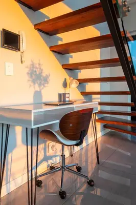a desk and a chair in a room with stairs at Penthouse with a view to die for! in Cape Town
