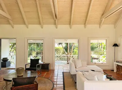 a living room with a couch and a table at Kumbuk House in Franschhoek
