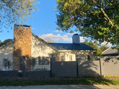 a white house with a gate and a fence at 33 Tafelberg! in Cape Town