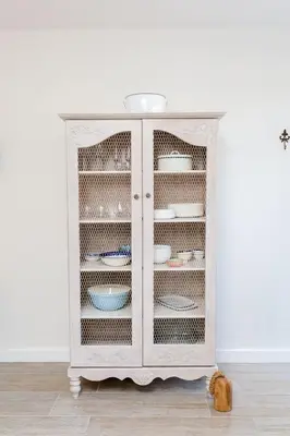 a white cabinet with plates and dishes in it at Waddle Inn Luxury apartment in Franschhoek in Franschhoek