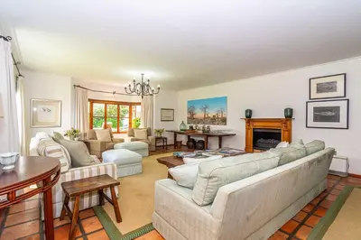 a living room with two couches and a fireplace at Fynbos House in Hermanus