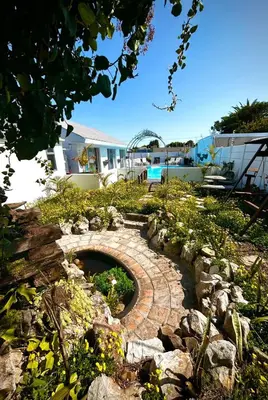 a garden with a stone walkway in a yard at Villa Rosa Luxury in Cape Town