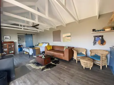 a living room with a couch and a bed at Skuilkrans Private Nature Reserve in McGregor