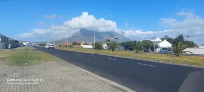 a view of a road with a mountain in the background at COMFORT LODGE milnerton, Cape Town in Cape Town