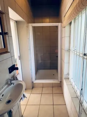a bathroom with a shower and a sink at Guest Suite in Tuscan Farmhouse in Paarl