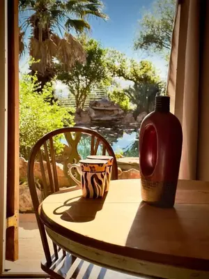a table with a vase and a cup on it at Guest Suite in Tuscan Farmhouse in Paarl