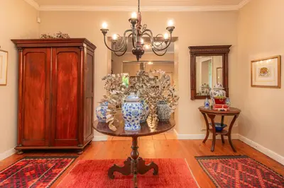 a room with a table with vases on it at Beautiful country house set in lush garden in Wellington