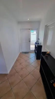 an empty room with a tiled floor and a door at Beautiful 4 bedroom home overlooking the ocean in Somerset West Cape Town in Cape Town