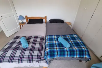 two beds sitting next to each other in a bedroom at Beautiful 4 bedroom home overlooking the ocean in Somerset West Cape Town in Cape Town
