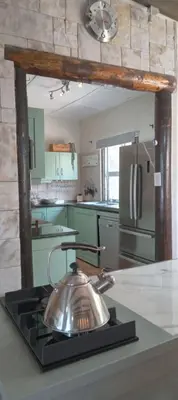 a kitchen with a tea kettle on top of a stove at Red Disa in Malkopvlei