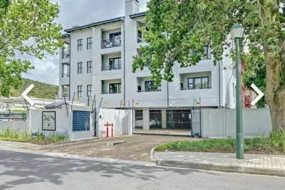 an apartment building on the corner of a street at Luxury at The Den in Stellenbosch