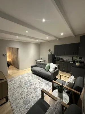 a living room with a couch and a table at Somerset-West PRIME SPOT- Solar Powered! in Cape Town