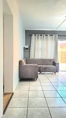 a living room with a couch and a window at Aeon Nest in Parow