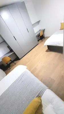 a bedroom with two beds and a large mirror at Aeon Nest in Parow