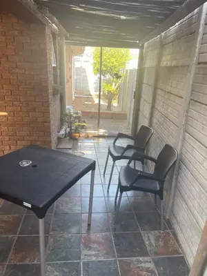 a patio with two chairs and a black table and chairs at Morrison Hotel in Parklands