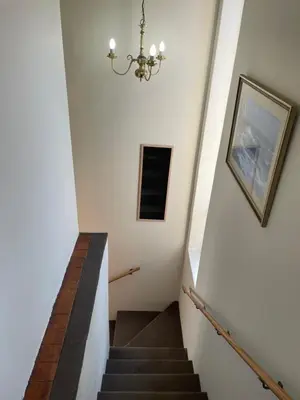 a staircase in a house with a chandelier at Morrison Hotel in Parklands