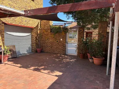a brick building with a garage with a door at Morrison Hotel in Parklands