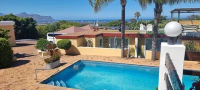 a house with a swimming pool in front of it at Big6 Guesthouse in Somerset West