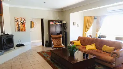 a living room with a couch and a coffee table at Big6 Guesthouse in Somerset West