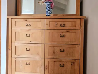 a wooden dresser with a mirror and a vase on it at PinotageLuxuryCollection 9A Herte Suite in Stellenbosch