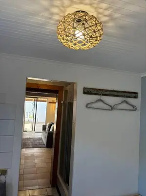 a ceiling with a chandelier on top of a hallway at Mountain Views, beach walks, heart of old village in Gordonʼs Bay