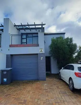 a white car parked in front of a house at Holihome in Brackenfell