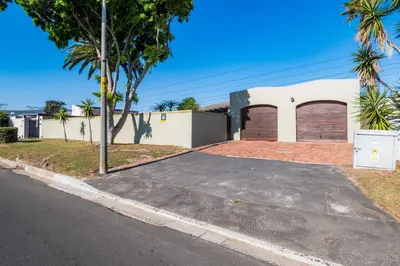 a house with two garage doors on a street at 59onLetchworth in Cape Town