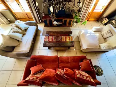 a living room with couches and a table at Tuscan Farmhouse near Franschhoek in Simondium