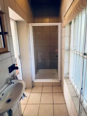 a bathroom with a shower and a sink at Tuscan Farmhouse near Franschhoek in Simondium